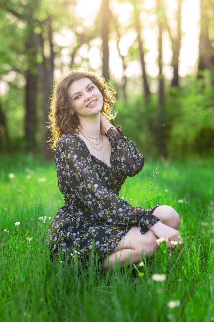 Senior girl poses in a field of flowers at Hayes Nature Preserve in Huntsville, Alabama