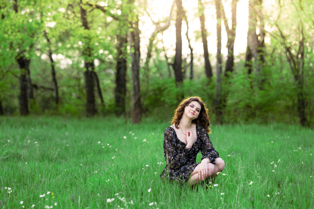 Senior girl poses in a field of wild flowers at Hayes Nature Preserve in Huntsville, Alabama