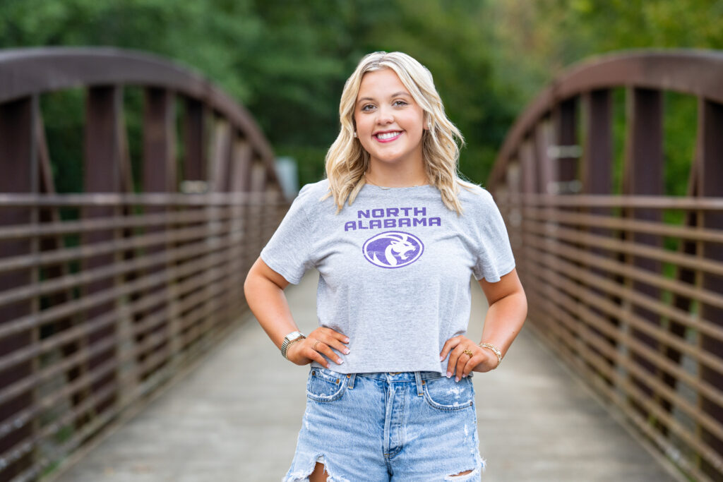 Senior girl standing on bridge at for pictures Hayes Nature Preserve in Huntsville AL